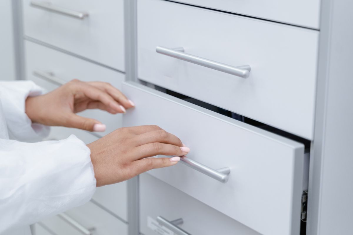 Close-up of a drawer being opened with simple metal hardware