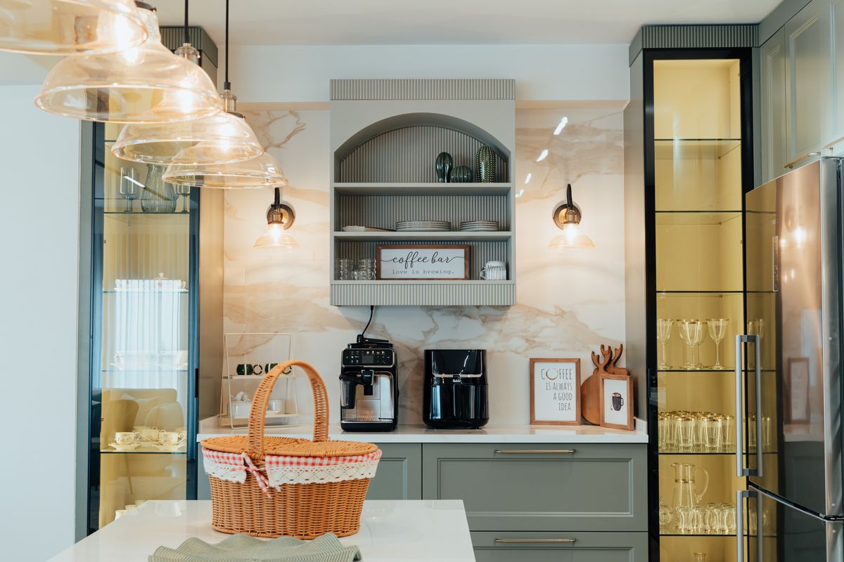 Kitchen coffee bar with glass front cabinet doors and warm lighting