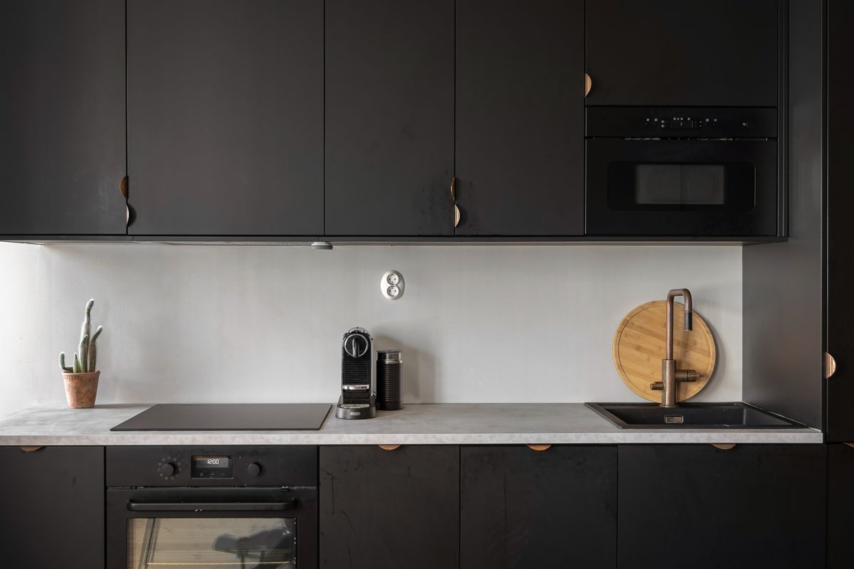 Dark matte lacquer kitchen cabinets with clean slab fronts