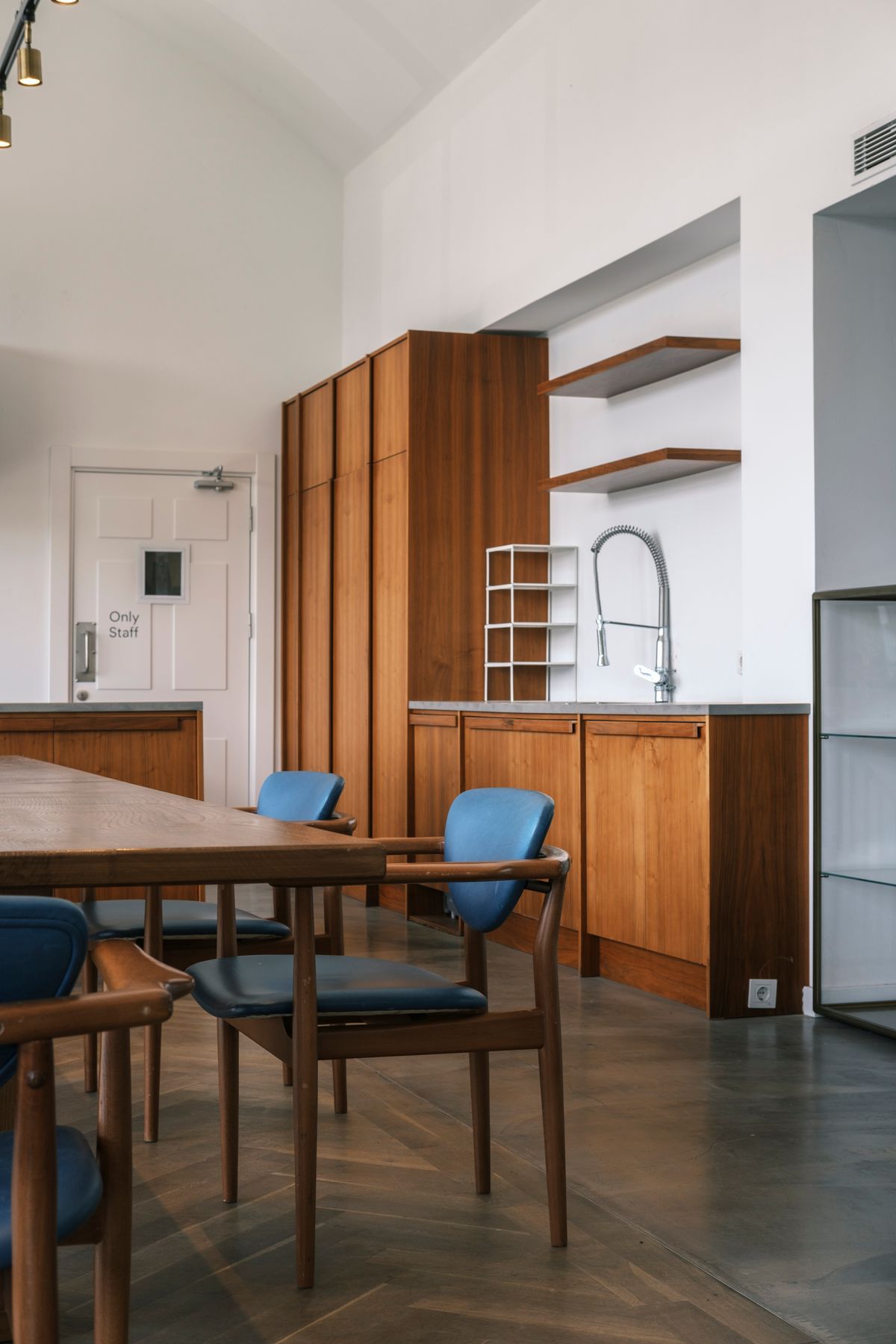 Warm wood kitchen cabinets with integrated panels and open shelves