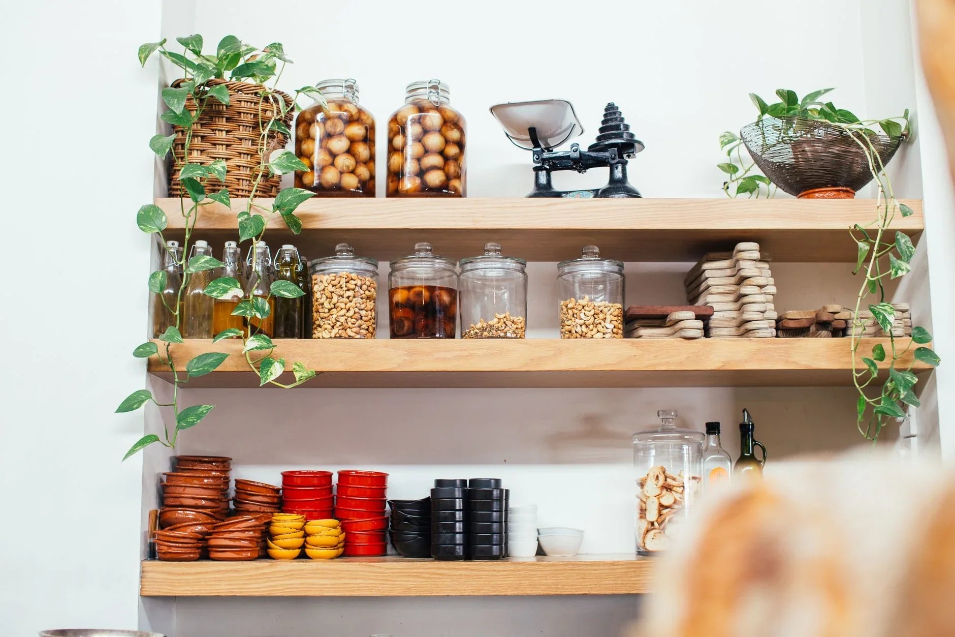 Custom walk-in pantry with wooden shelving and organized food storage