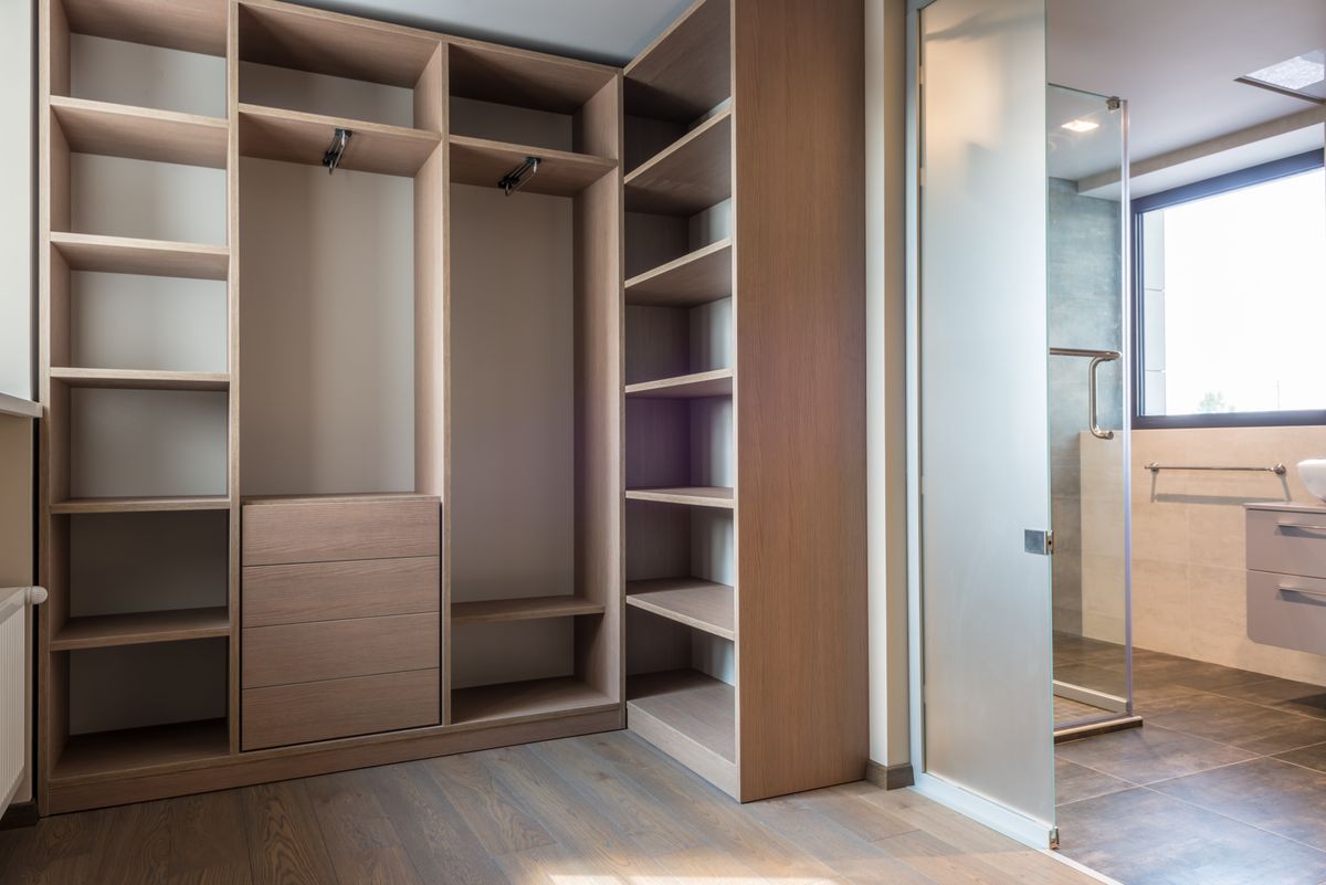 Wood walk-in closet system with drawers, shelves, and hanging zones