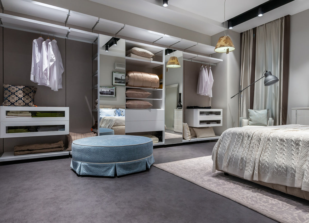Bedroom with a built-in wardrobe and upholstered stool